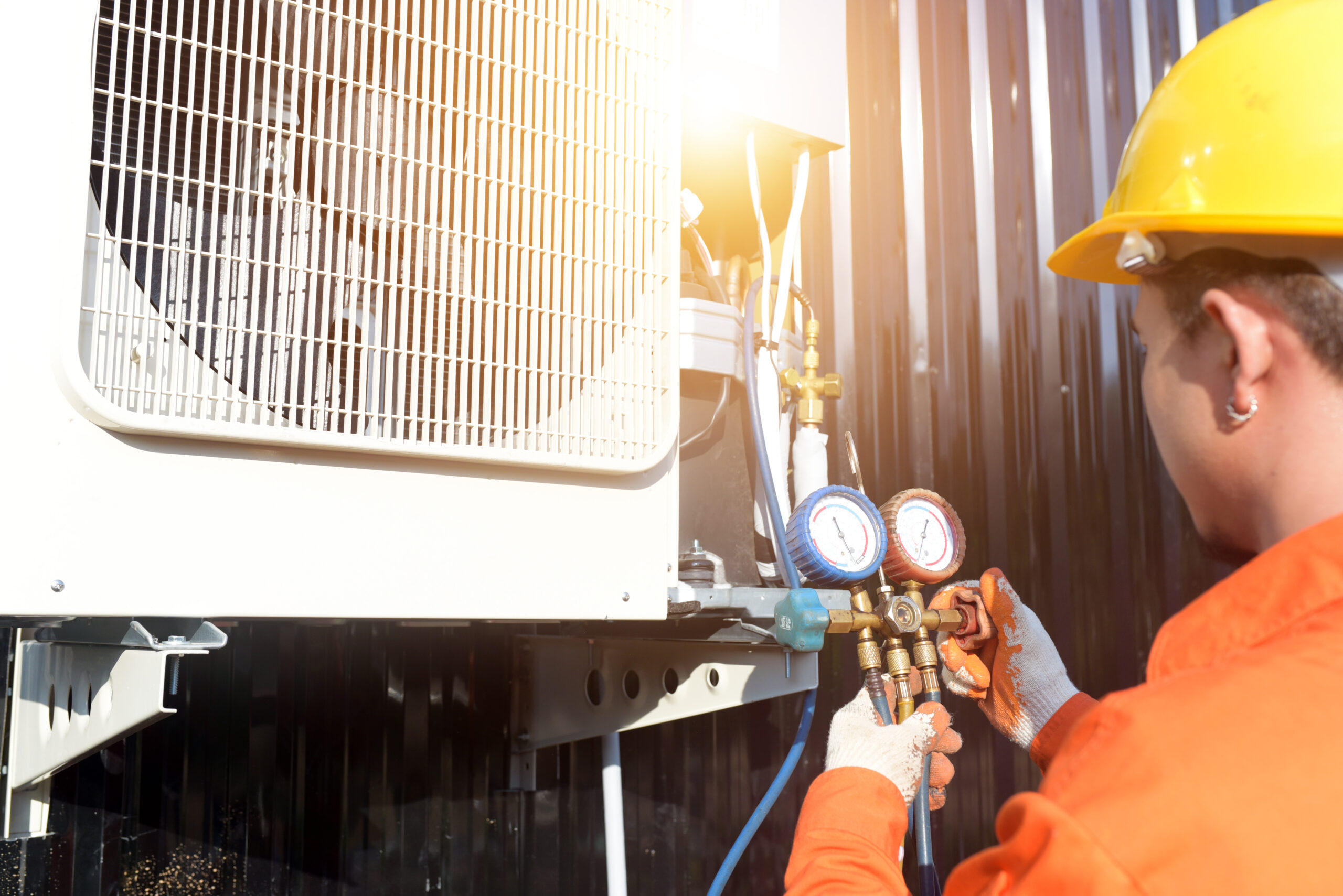 A professional air conditioner technician checking the refrigera AC, heating, plumbing, refrigeration